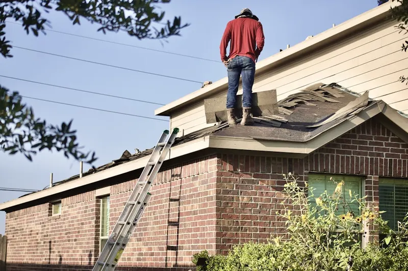 Professional roofer working on a residential roof in Rockview